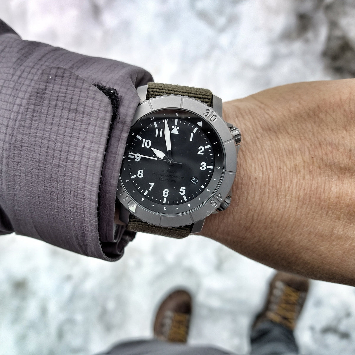 COURG42 titanium watch worn on a snowy hike.