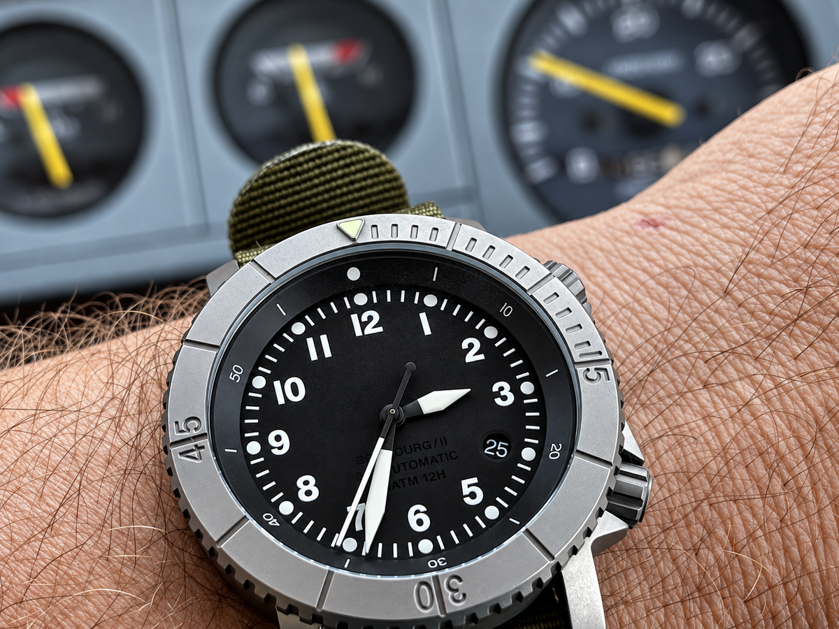 COURG42 A-11 titanium instrument watch beside cockpit gauges