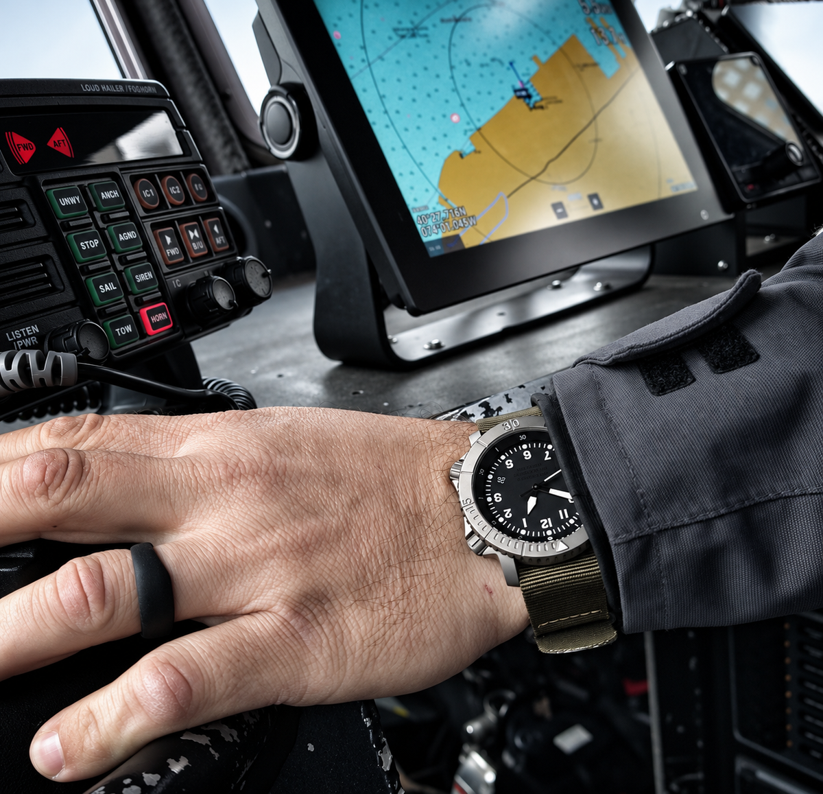 COURG42 A-11 worn at a vessel helm beside navigation equipment