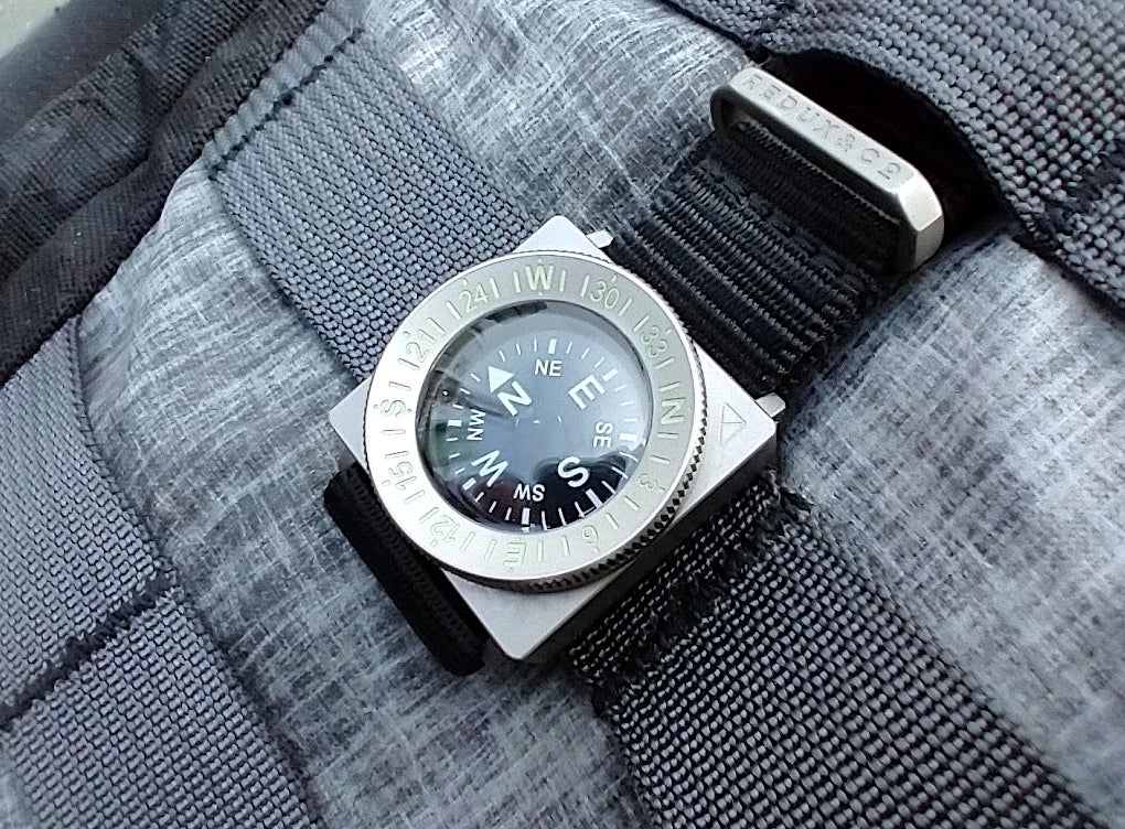 SCOUT-C compass module showing the liquid-filled lumed dial and bearing bezel.