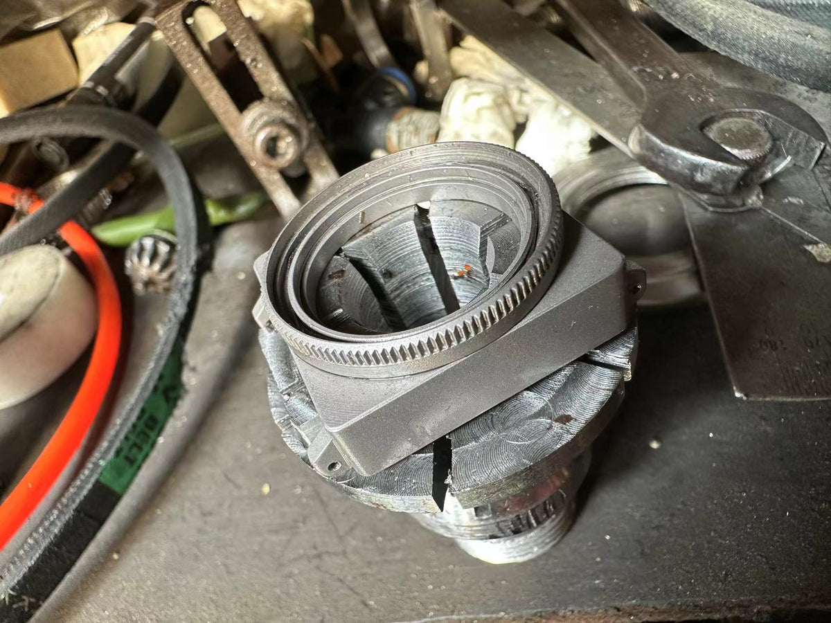 Redux titanium watch case in a workshop fixture during development